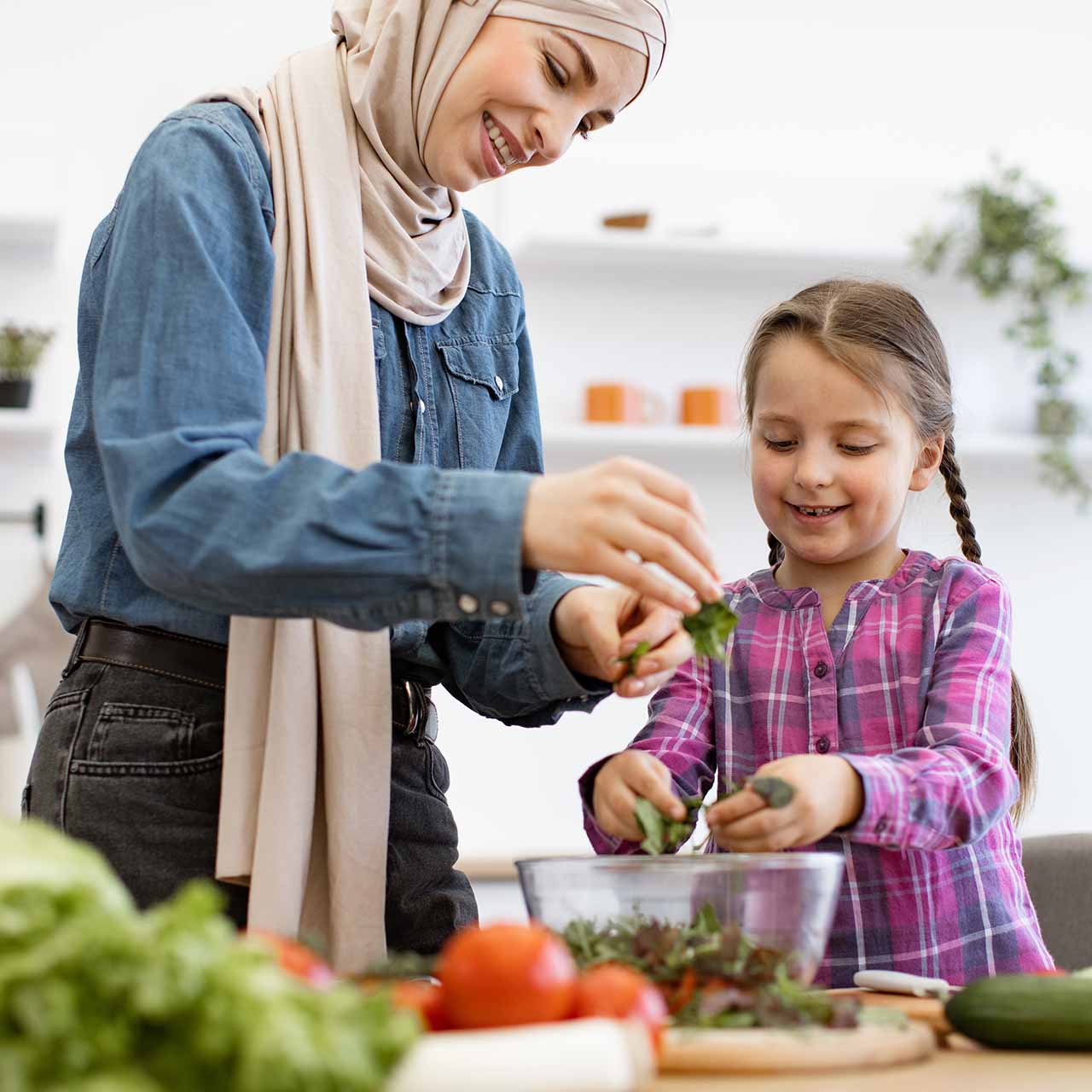 A woman cooking with her daughter