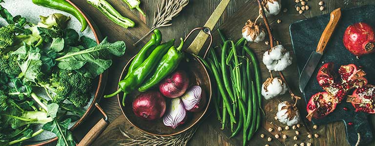 Vegetables and flowers spread across a wooden table