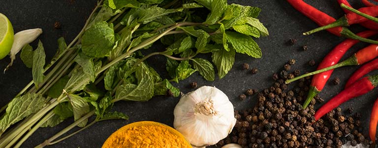 Vegetables and spices displayed on a slate table