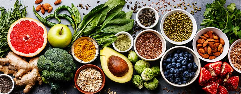A collage of vibrant whole foods displayed across a table